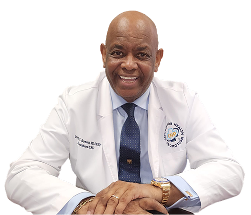 Dr. Reynolds in white labjacket, white shirt and blue tie smiles.